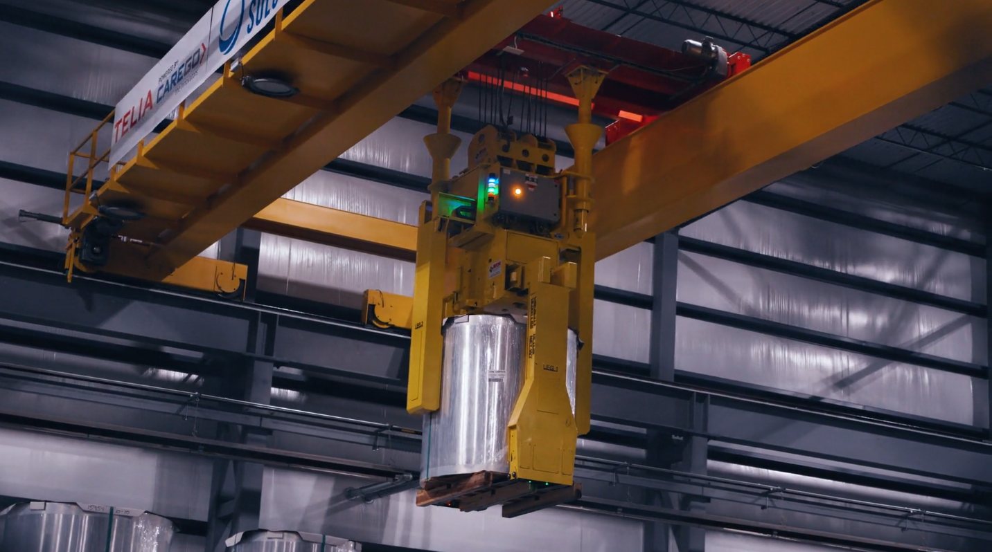 Crane grab lifting a palletized steel coil